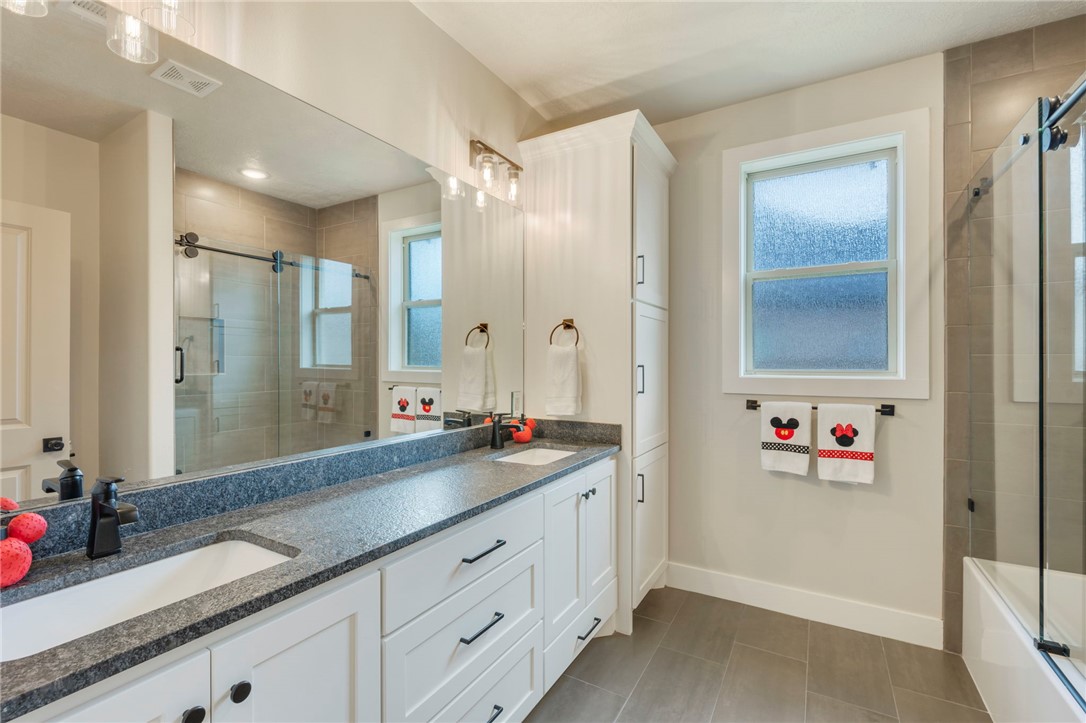 4804 Crystal Ridge Court College Station, TX 77845 - Photo 34 of 48 a bathroom with a granite countertop sink mirror and double