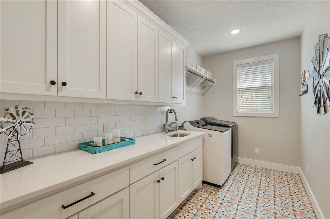 4804 Crystal Ridge Court College Station, TX 77845 - Photo 38 of 48 a kitchen with stainless steel appliances white cabinets and a stove top oven