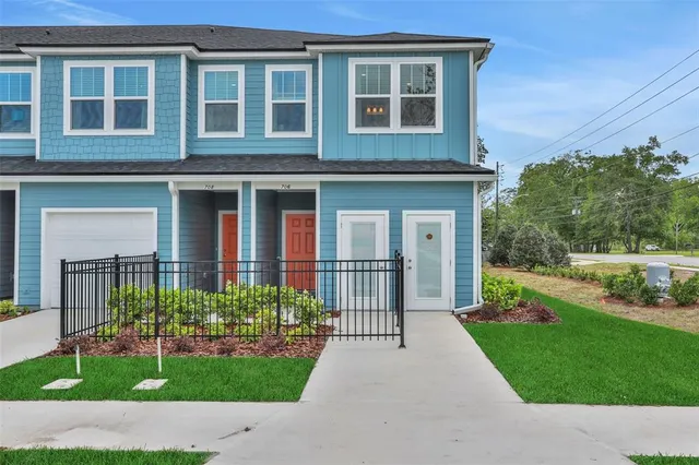 a view of a house with a garden and pathway