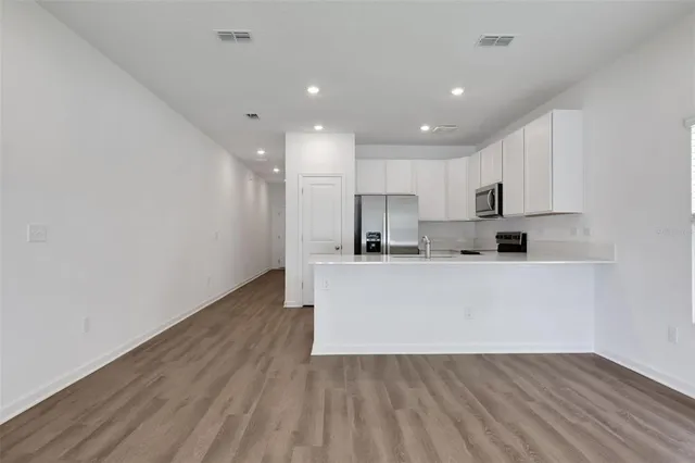 a view of kitchen with wooden floor and window