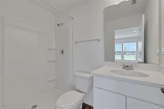 a bathroom with a sink toilet and vanity