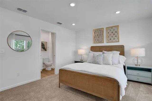 a bedroom with a bed and a lamp