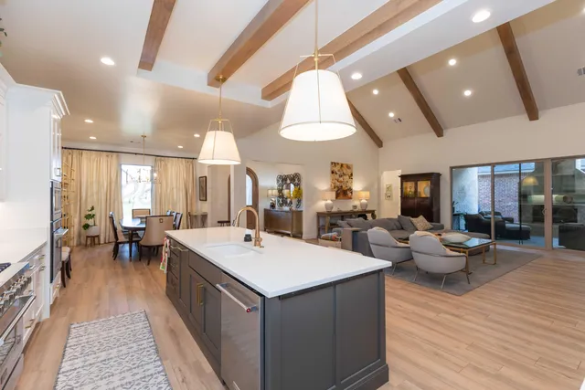 a kitchen with a sink cabinets and chairs