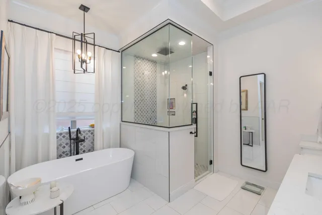 a bathroom with a bathtub and shower