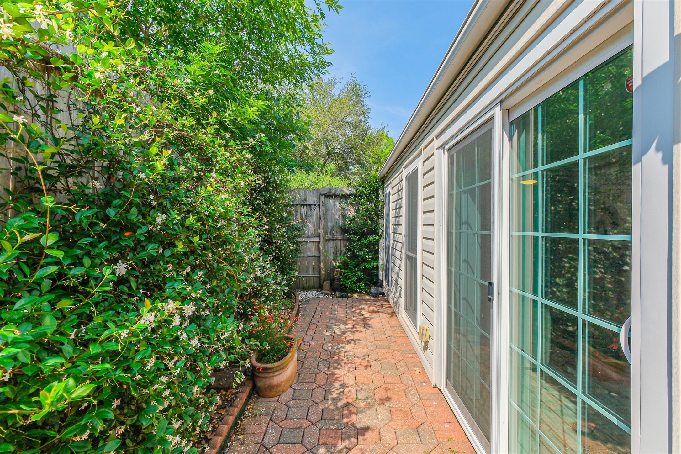1007 Arrow Hill Road Houston, TX 77077 - Photo 37 of 48 There is a cozy brick patio/walkway outside the den that leads to the back green space.