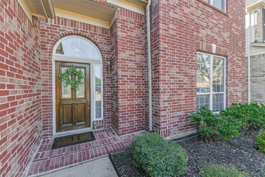 19022 Greenleaf Ridge Court Cypress, TX 77429 - Photo 7 of 47 a view of a brick house with a large windows