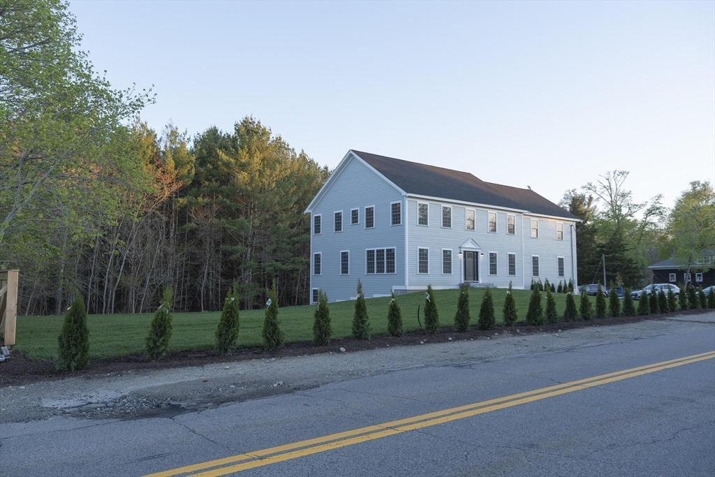 28 Marion Road Rochester, MA 02770 - Photo 9 of 23 a view of a white house next to a road and yard