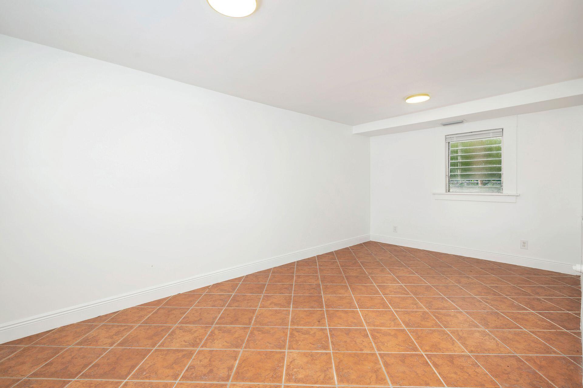 232 Rugby Road West Palm Beach, FL 33405 - Photo 24 of 40 an empty room with a white wall and a window