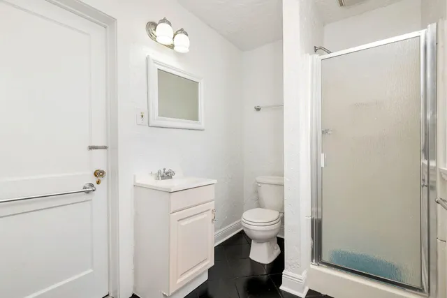a bathroom with a toilet sink and a mirror