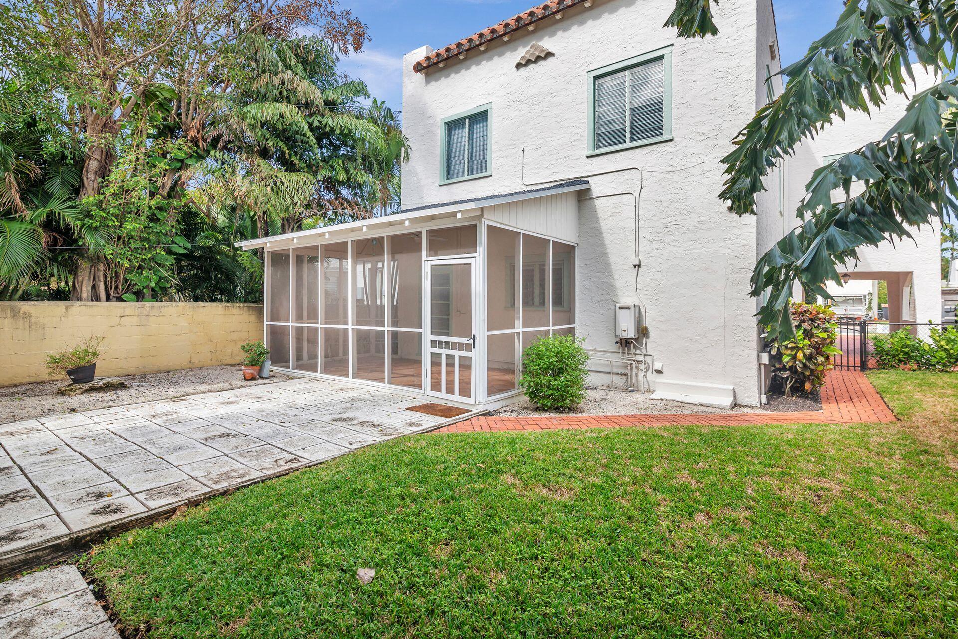 232 Rugby Road West Palm Beach, FL 33405 - Photo 28 of 40 front view of a house with a yard and potted plants