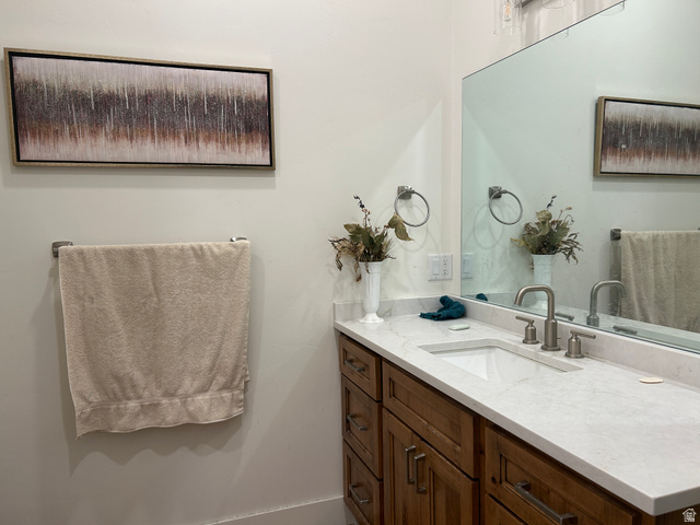 2688 Read Lane Preston, ID 83263 - Photo 12 of 18 Bathroom vanity featuring a light-colored countertop, an undermount sink, and a brushed nickel faucet