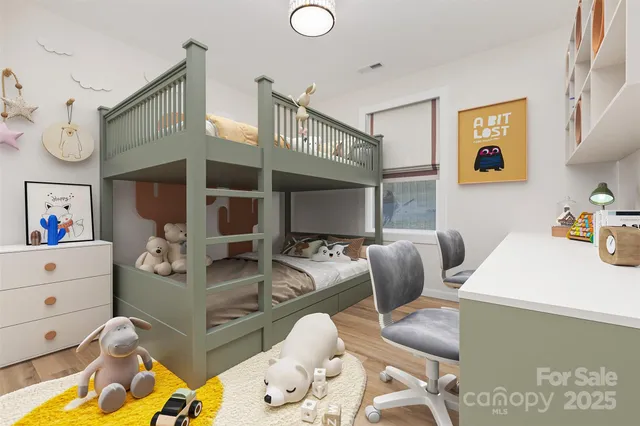 a living room with furniture and baby bed