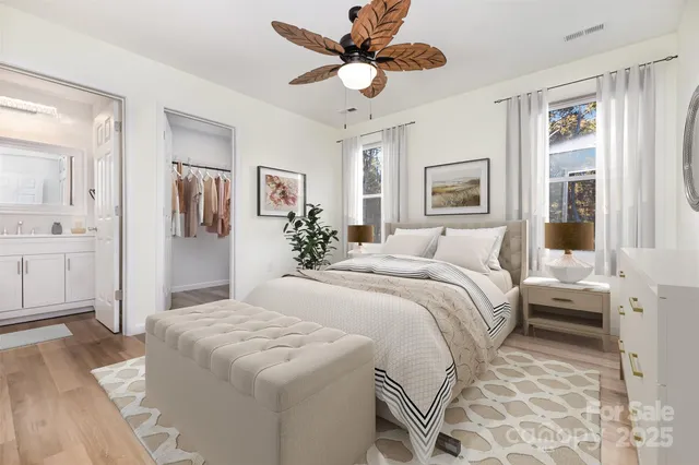 a spacious bedroom with a bed and a chandelier