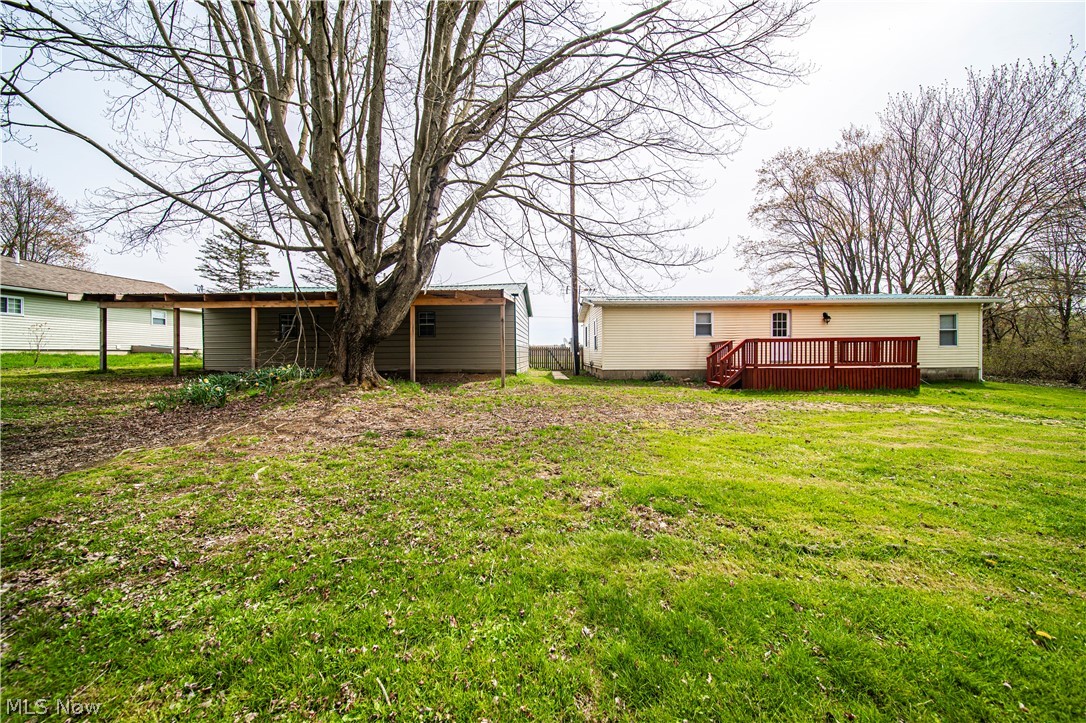 3501 Pymatuning Lake Road Andover, OH 44003 - Photo 11 of 36 View of yard with a wooden deck, rear garage with lean-to
