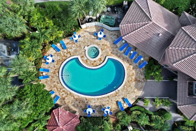 a view of a lake with a big yard and large trees