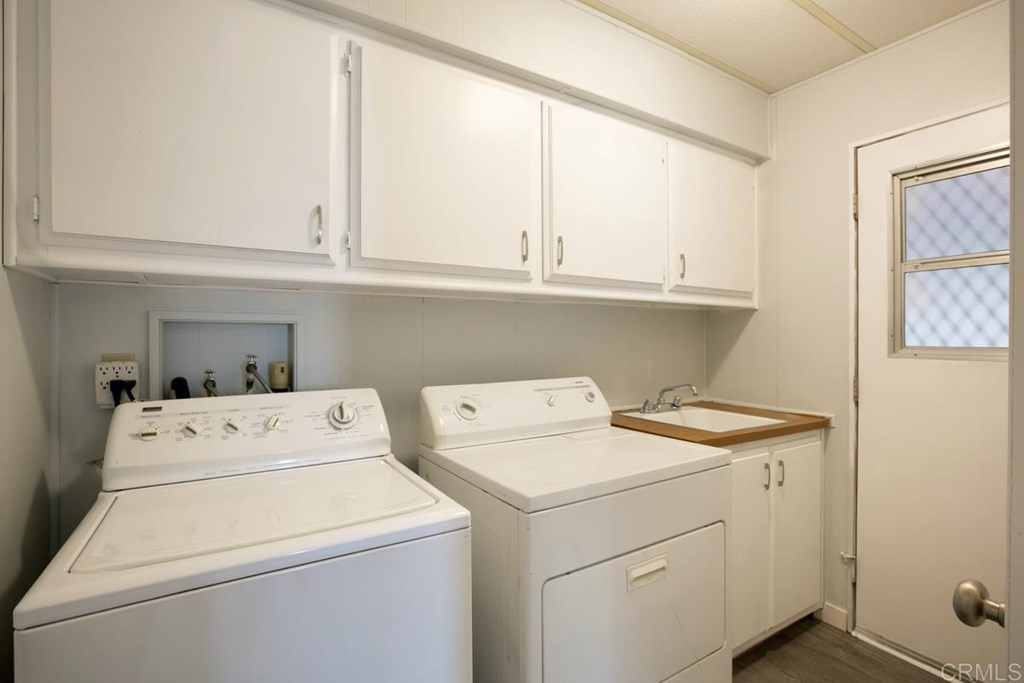 2250 North Broadway, Unit 10 Escondido, CA 92026 - Photo 20 of 30 The washer and dryer convey with the home. There is a utility sink and plenty of storage cabinets.
