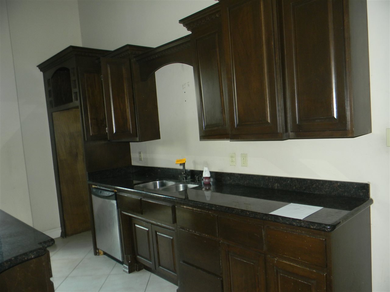 205 Lake Como Road Laredo, TX 78041 - Photo 10 of 20 a kitchen with granite countertop white cabinets and black appliances
