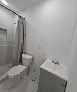 a bathroom with a toilet a sink and a mirror