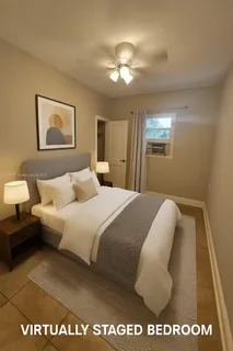 a bedroom with a bed and a painting on the wall