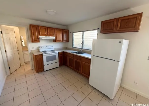 a kitchen with stainless steel appliances a refrigerator sink and cabinets