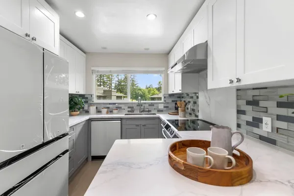 a kitchen with a sink stove and refrigerator