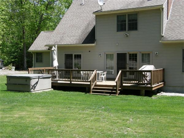 111 Pierpont Road Dudley, MA 01571 - Photo 4 of 30 a view of a house with a patio deck and a patio