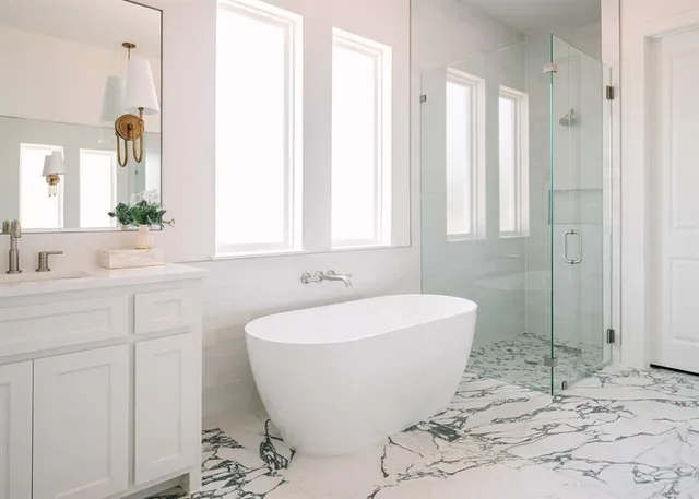 a bathroom with a bathtub and shower