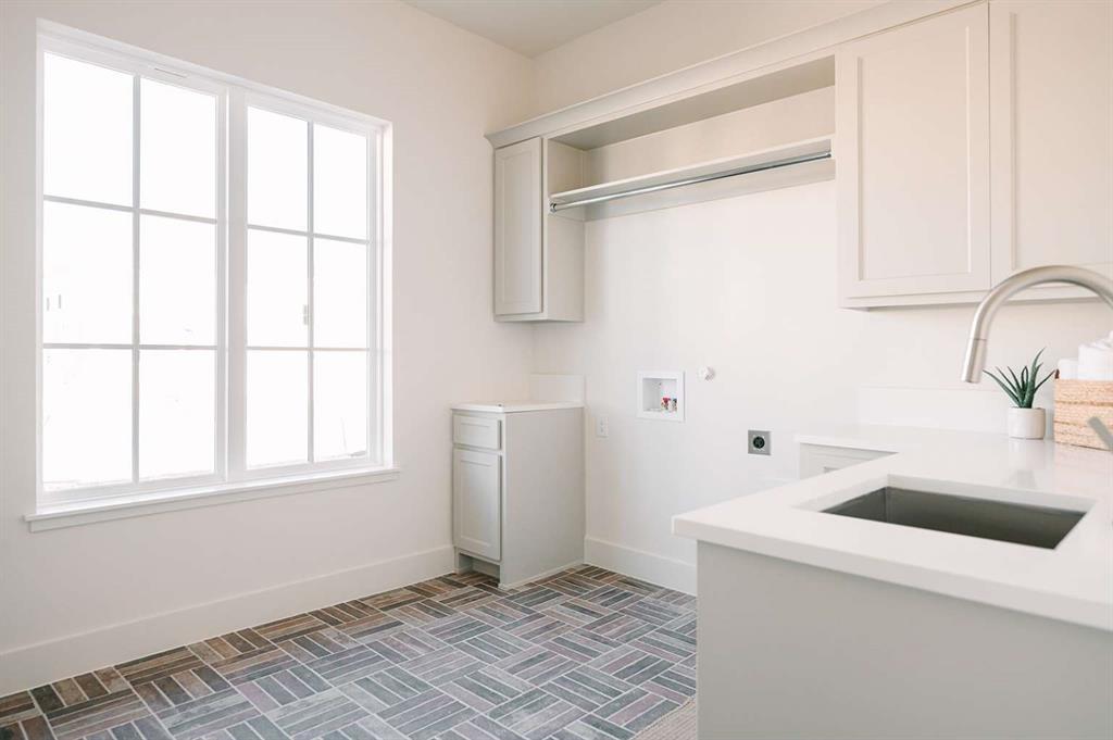 405 Kestrel Court Aledo, TX 76008 - Photo 16 of 31 a kitchen with a sink cabinets and window