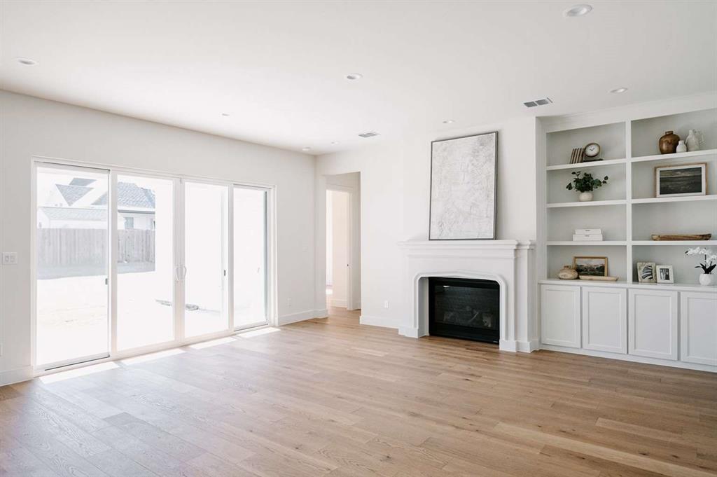 405 Kestrel Court Aledo, TX 76008 - Photo 3 of 31 a view of a livingroom with an empty space and a fireplace