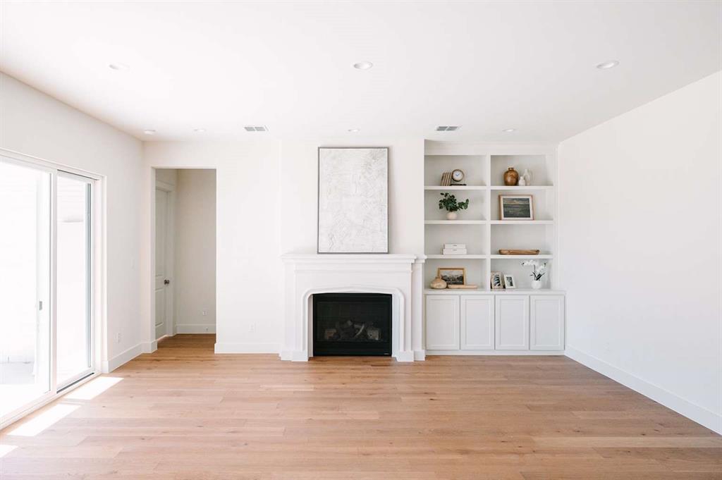 405 Kestrel Court Aledo, TX 76008 - Photo 4 of 31 a view of empty room with a fireplace and cabinet