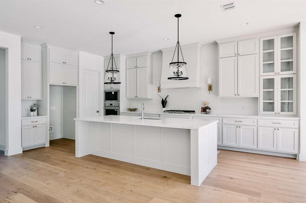 405 Kestrel Court Aledo, TX 76008 - Photo 7 of 31 a kitchen with white cabinets and window