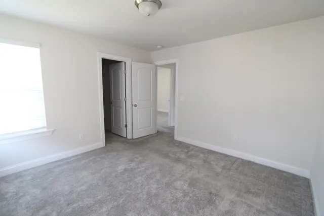 a view of an empty room and a window