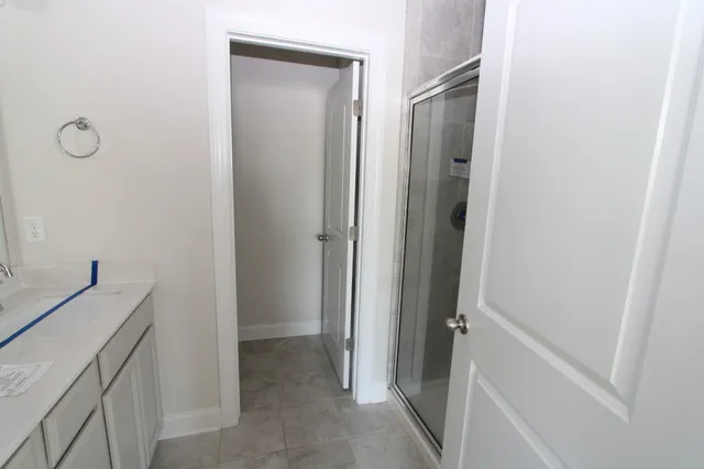 a view of a bathroom from a hallway