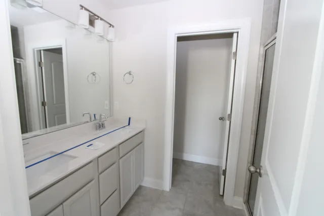 a bathroom with a double vanity sink and mirror