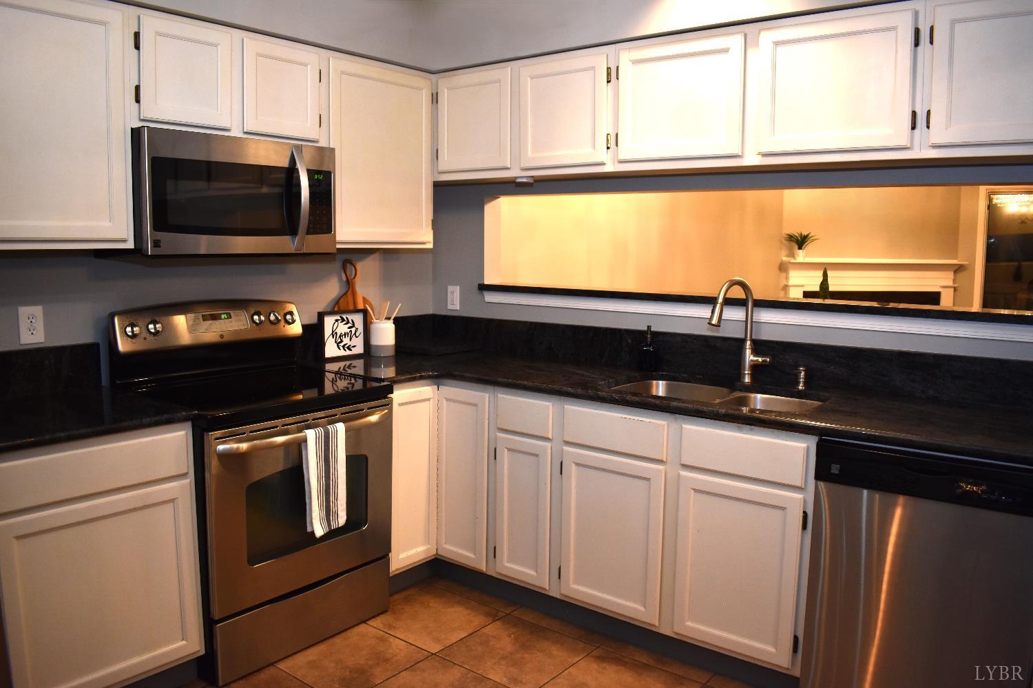482 Oak Point Road Forest, VA 24551 - Photo 12 of 39 a kitchen with a stove and a microwave