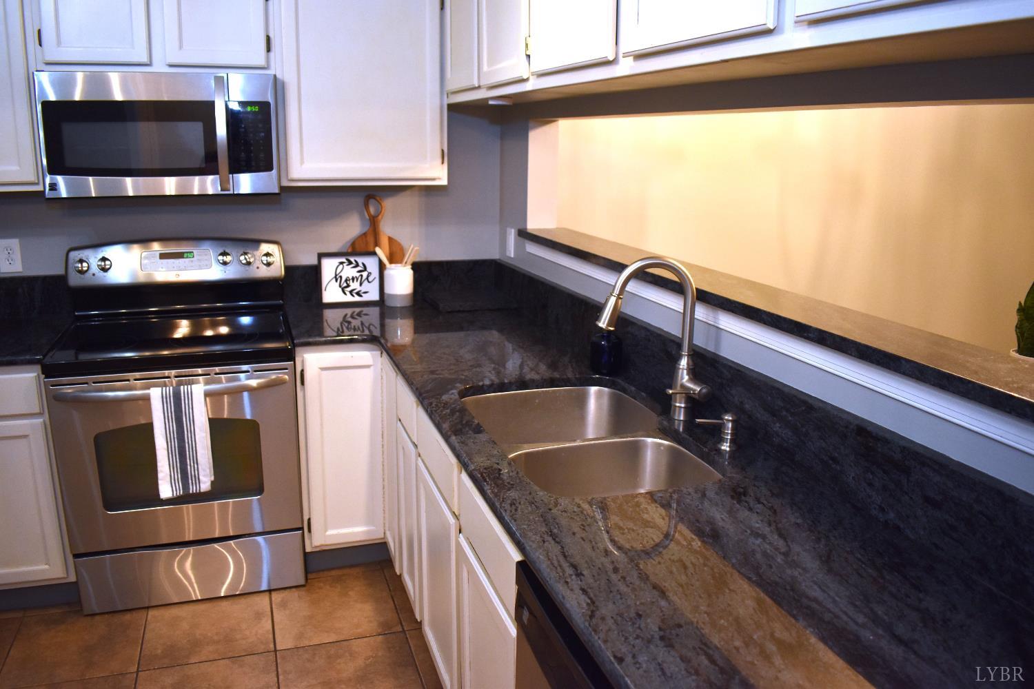 482 Oak Point Road Forest, VA 24551 - Photo 13 of 39 a kitchen with granite countertop a sink stainless steel appliances and cabinets