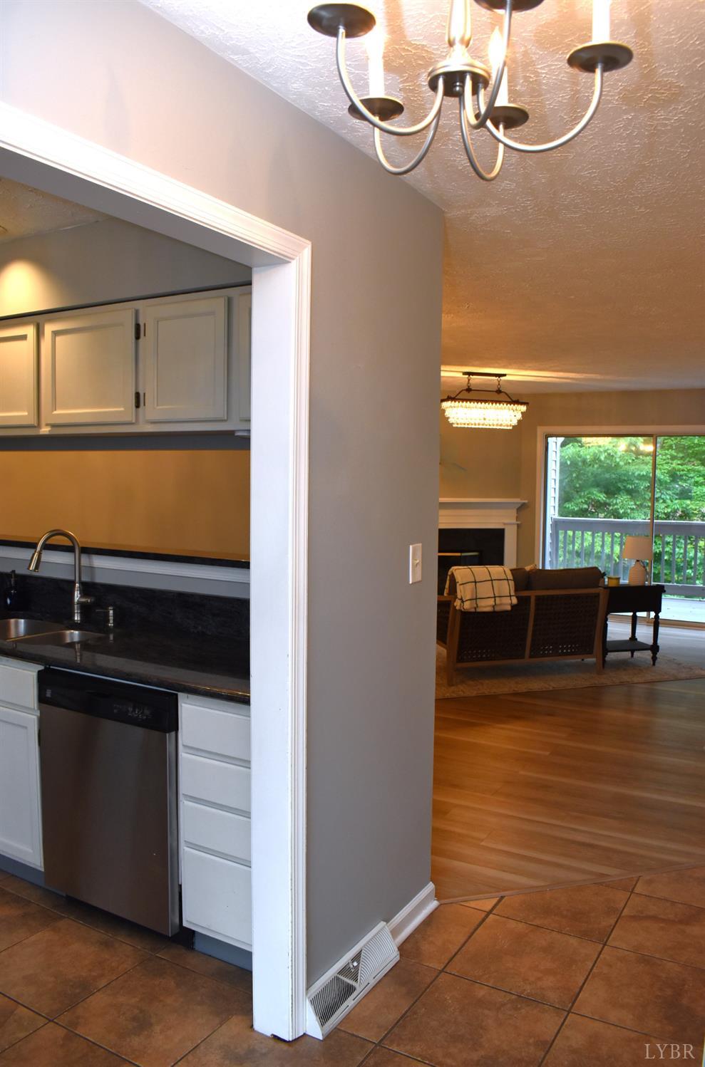 482 Oak Point Road Forest, VA 24551 - Photo 18 of 39 a view of a livingroom with furniture hardwood floor and a kitchen
