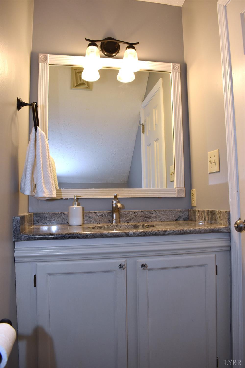 482 Oak Point Road Forest, VA 24551 - Photo 19 of 39 a bathroom with a granite countertop sink and a mirror