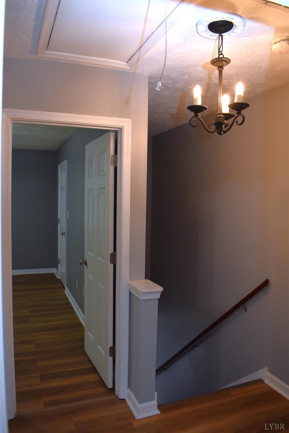 482 Oak Point Road Forest, VA 24551 - Photo 21 of 39 a view of a hallway with wooden floor and staircase