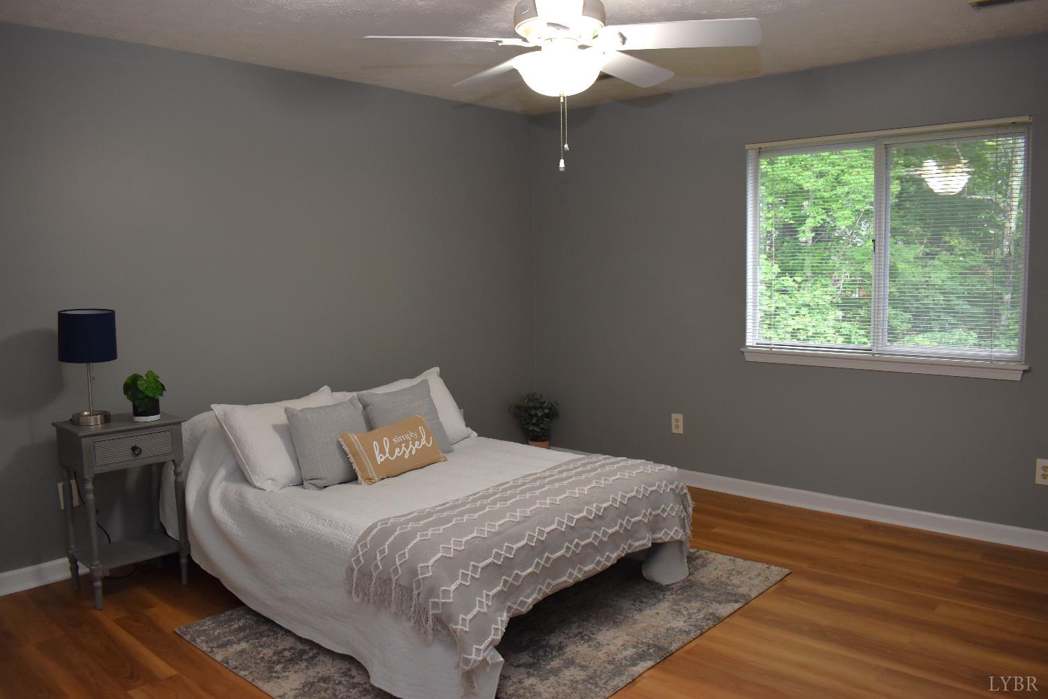 482 Oak Point Road Forest, VA 24551 - Photo 23 of 39 a bedroom with a bed and wooden floor