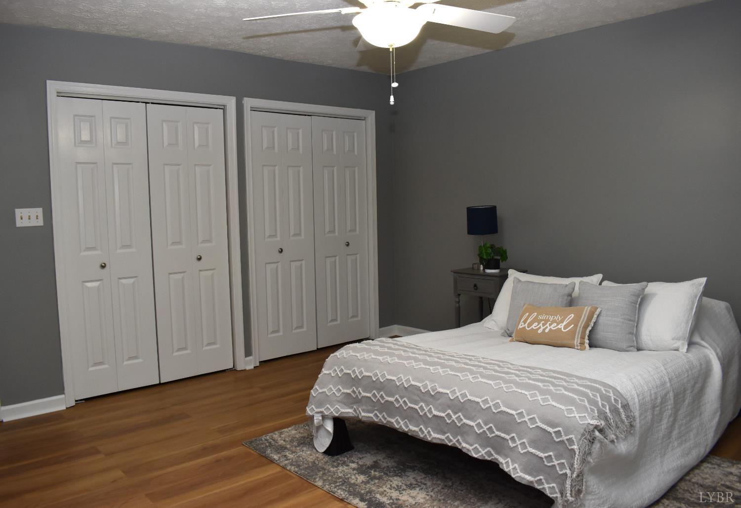482 Oak Point Road Forest, VA 24551 - Photo 24 of 39 a bedroom with a bed and a chandelier