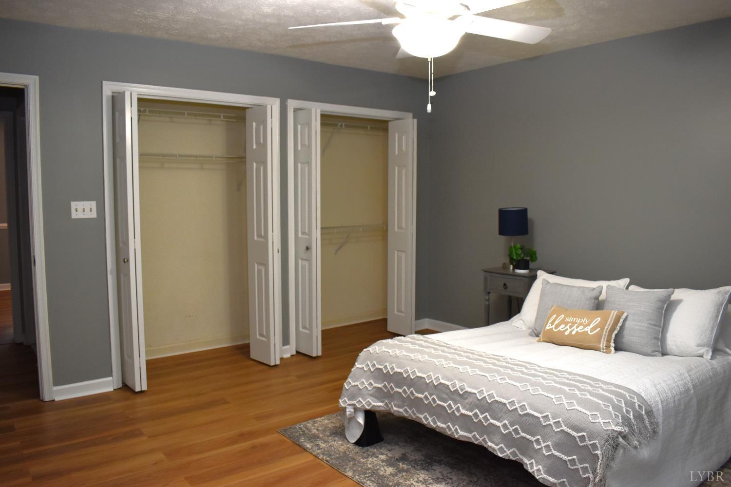 482 Oak Point Road Forest, VA 24551 - Photo 25 of 39 a bedroom with a bed and a chandelier