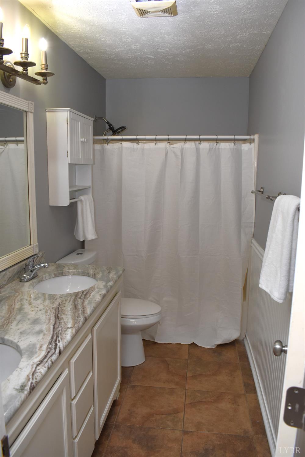482 Oak Point Road Forest, VA 24551 - Photo 33 of 39 a bathroom with a granite countertop sink and a mirror