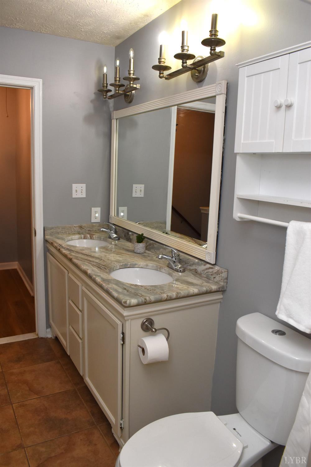482 Oak Point Road Forest, VA 24551 - Photo 35 of 39 a bathroom with a granite countertop toilet sink and mirror