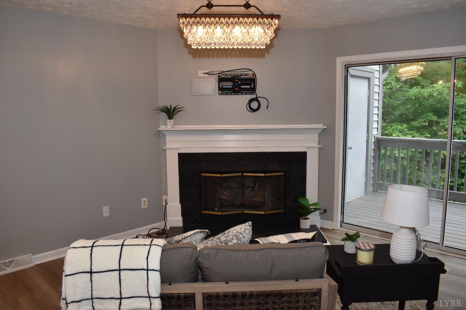 482 Oak Point Road Forest, VA 24551 - Photo 6 of 39 a living room with furniture and a fireplace
