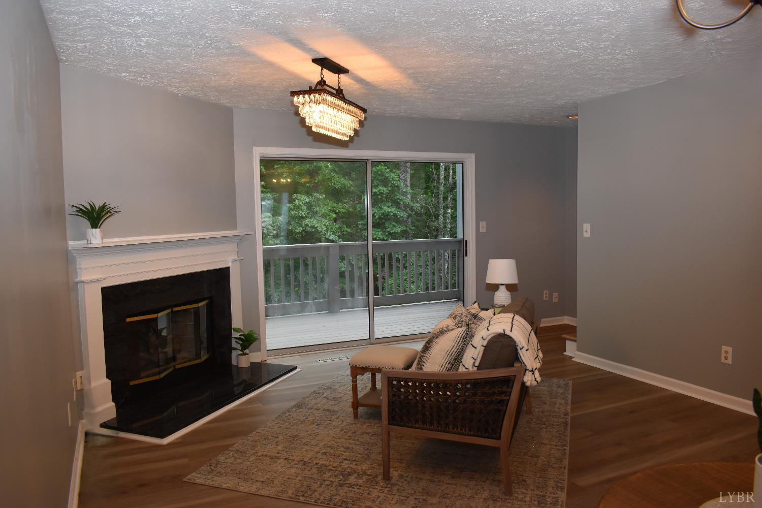 482 Oak Point Road Forest, VA 24551 - Photo 9 of 39 a living room with furniture a window and a fireplace