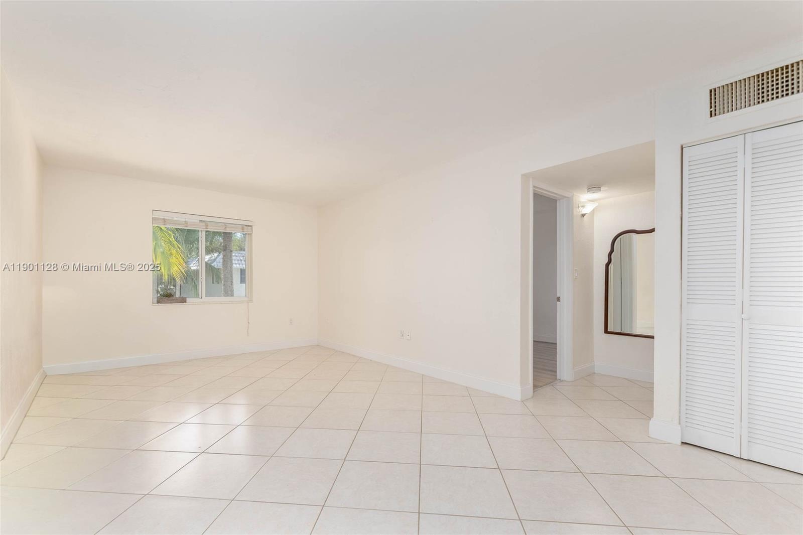 8605 Southwest 68th Court, Unit 22 Pinecrest, FL 33156 - Photo 1 of 10 an empty room with entrance and windows