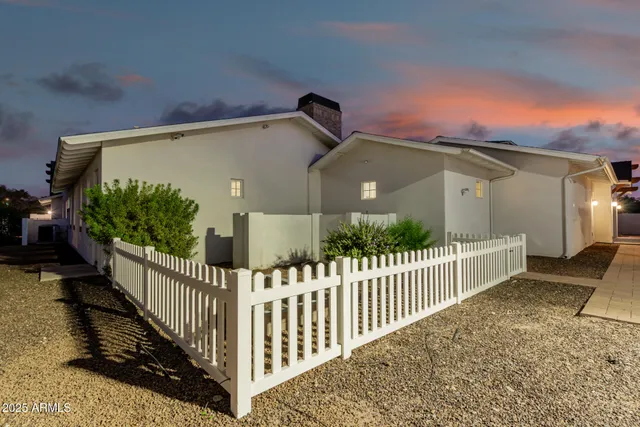 a view of a house with swimming pool and sitting area