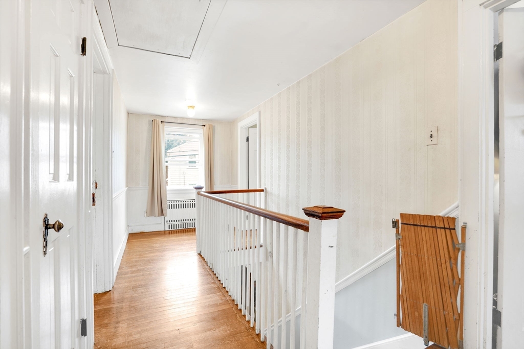 39 Range Road Boston, MA 02124 - Photo 11 of 25 a view of a hallway with wooden floor and staircase