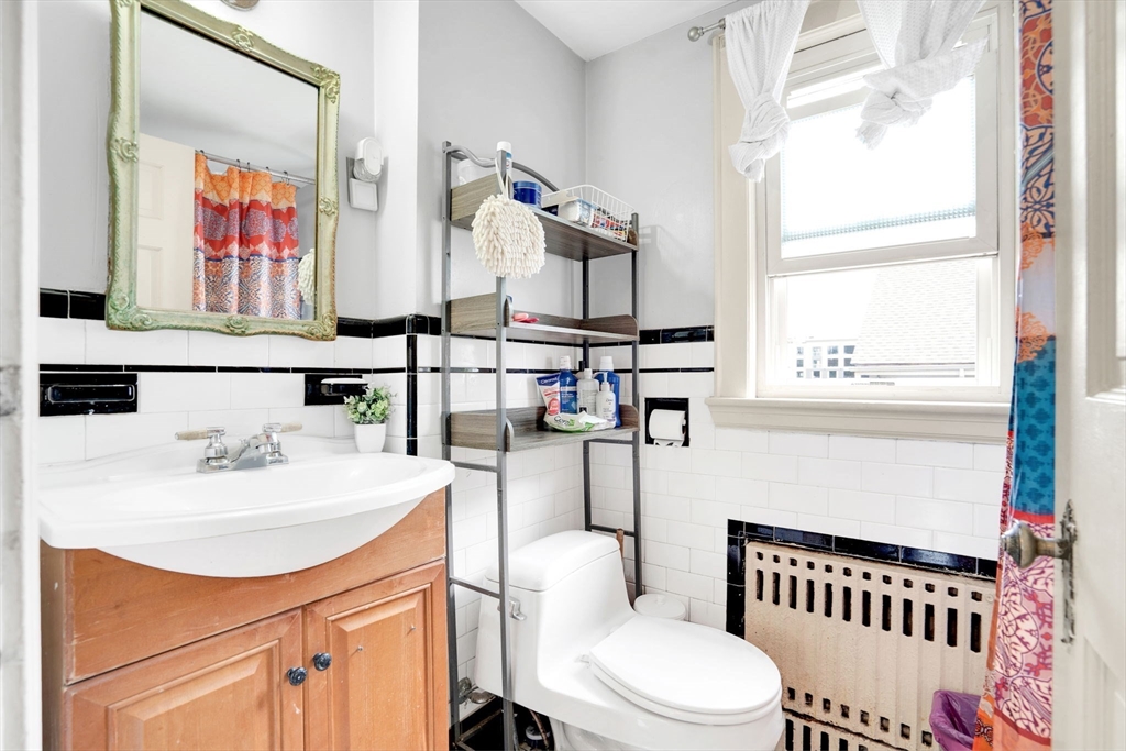 39 Range Road Boston, MA 02124 - Photo 13 of 25 a bathroom with a sink a toilet and a window